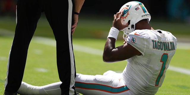 Miami Dolphins quarterback Tua Tagovailoa sits on the turf during the first half of the game against the Buffalo Bills at Hard Rock Stadium in Miami Gardens, Florida, on Sept. 25, 2022.