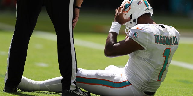 Quarterback Tua Tagovailoa sits on the turf at Hard Rock Stadium on Sept. 25, 2022, in Miami Gardens, Florida.