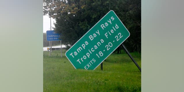 A damaged sign sits on the side of state road I-275 as Hurricane Ian approaches on September 28, 2022 in St. Petersburg, Florida.  