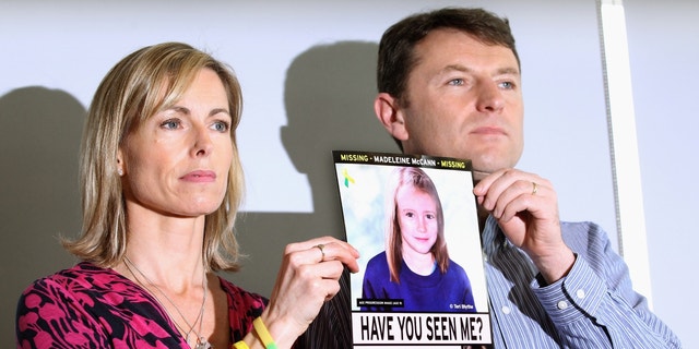 Kate and Gerry McCann holding a photo