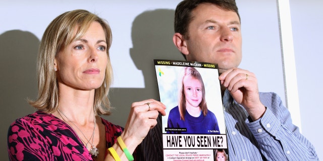 Kate and Gerry McCann holding a photo