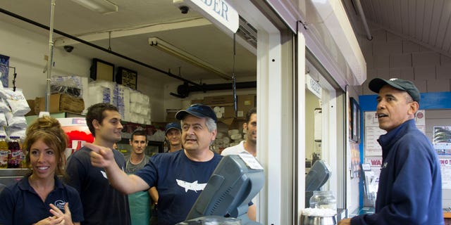 Former President Barack Obama, right, visits Nancy's restaurant on Martha's Vineyard in Oak Bluffs, Massachusetts. The Obamas own a $12 million property in the wine town of Chilmark; one of the lowest property tax rates in the state.