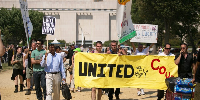 Demonstrators march across the National Mall during the Million American March Against Fear, which was initially called the "Million Muslim March," on Capitol Hill, Sept. 11, 2013, in Washington, D.C.