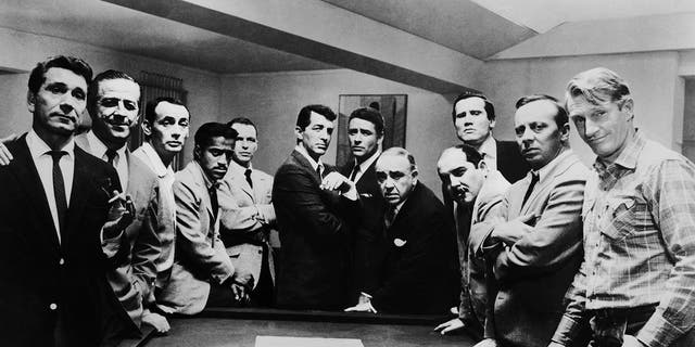 Promotional portrait of the cast of the film, "Oceans Eleven," left to right: Richard Conte, Buddy Lester, Joey Bishop, Sammy Davis Jr., Frank Sinatra, Dean Martin, Peter Lawford, Akim Tamiroff, Richard Benedict, Henry Silva, Norman Fell, and Clem Harvey. 