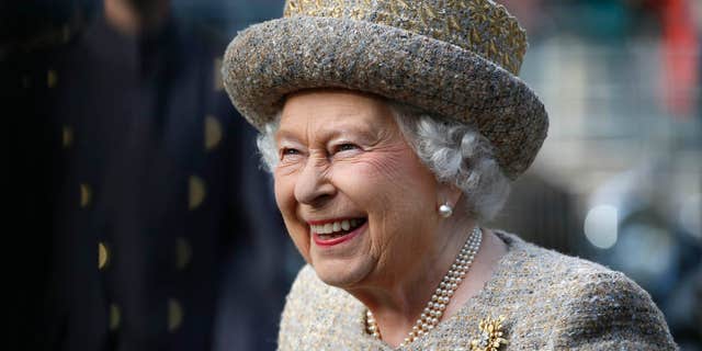 Queen Elizabeth II smiles as she arrives before the Opening of the Flanders' Fields Memorial Garden at Wellington Barracks on November 6, 2014, in London, England.