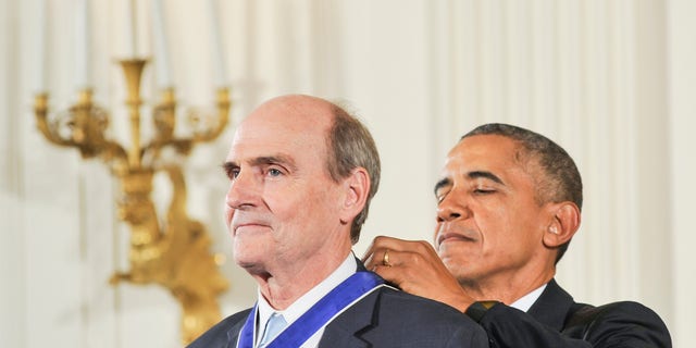 Former President Barack Obama presents James Taylor with the Presidential Medal of Freedom during the 2015 Presidential Medal Of Freedom ceremony.