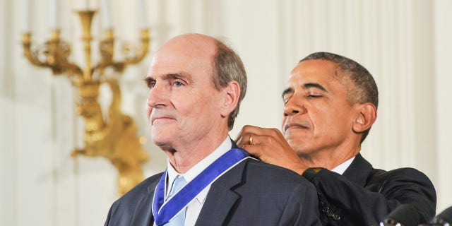 Former President Barack Obama presents James Taylor with the Presidential Medal of Freedom during the 2015 Presidential Medal Of Freedom ceremony.