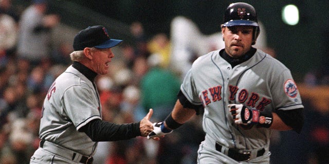 New York Mets' Mike Piazza (L) is congratulated by third base coach John Stearns (L) after Piazza hit a first inning home run driving in Edgardo Alfonzo April 3, 2001, against the Atlanta Braves at Turner Field in Atlanta. The Mets beat the Braves 6-4. 