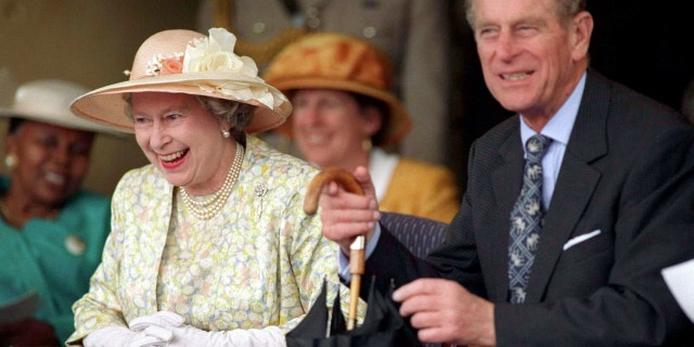 Queen Elizabeth seen laughing with Prince Philip during a trip to South Africa in 1995.