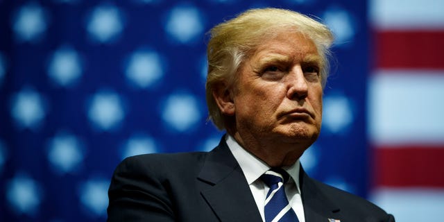 Donald Trump looks on during a rally at the DeltaPlex Arena.