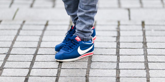 Nike Cortez blue shoes, worn by Sidya Sarr, fashion and lifestyle blogger @theparisian in Paris, France. First created by Bill Bowerman, the Cortez has been one of the world's most popular sneakers for a half century.  