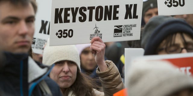 Opponents of the Keystone XL and Dakota Access pipelines hold a rally as they protest US President Donald Trump's executive orders advancing their construction, at Lafayette Park next to the White House in Washington, DC, on January 24, 2017. US President Donald Trump signed executive orders Tuesday reviving the construction of two controversial oil pipelines, but said the projects would be subject to renegotiation.  / AFP / SAUL LOEB        (Photo credit should read SAUL LOEB/AFP via Getty Images)