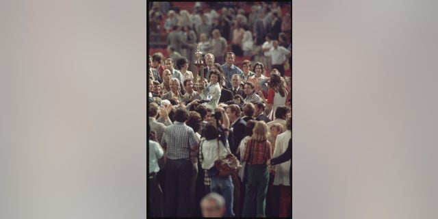 In the "Battle of the sexes," Billie Jean King emerged victorious and was surrounded by fans and media after defeating Bobby Riggs at the Astrodome in Houston, Texas on September 20, 1973.