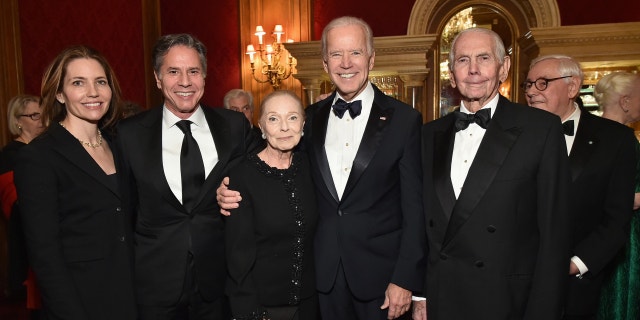 Secretary of State Antony Blinken seen standing with his father Donald Blinken (far right), who served as U.S. Ambassador to Hungary, in a 2017 photo with now-President Joe Biden.