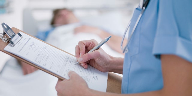 Photo of nurse tending to sick patient.