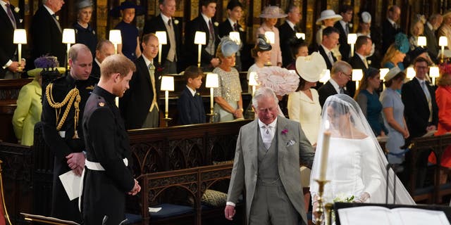 Instead of being led down the aisle with her own father, Meghan Markle was accompanied by Prince Harry's father, the new reigning monarch, King Charles III.