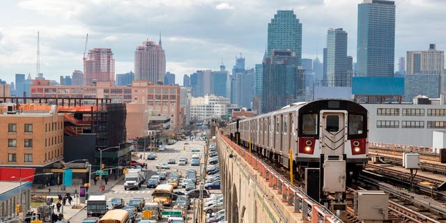 Train approaching elevated subway station in Queens, New York.