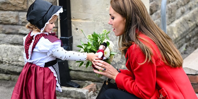 Catherine, Princess of Wales, meets 2-year-old Charlotte Bunting as she leaves St. Thomas Church in Swansea, Wales, on Sept. 27, 2022.