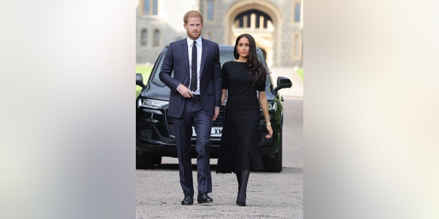 The Duke and Duchess of Sussex, arrive at the long walk at Windsor Castle to view flowers and tributes to Queen Elizabeth, Sept. 10, 2022, in Windsor, England.