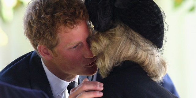 Prince Harry greets Queen Consort Camilla (then Duchess of Cornwall) as they attend a thanksgiving service for Gerald Ward, godfather of Prince Harry, at St Mary's Church, Chiltern Foliat on October 3, 2008, near Hungerford, England. Several palace insiders alleged that Harry's relationship with Camilla has become strained.