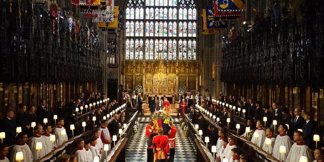 The coffin of Queen Elizabeth II is carried by pallbearers from the Queen's Company, 1st Battalion Grenadier Guards during the Committal Service for Queen Elizabeth II at St George's Chapel, Windsor Castle on Sept. 19, 2022, in Windsor, England.