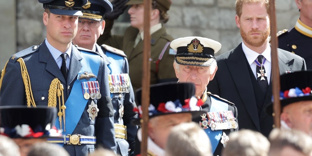 Prince William, King Charles III and Prince Harry look at the coffin of Queen Elizabeth during the state funeral at Westminster Abbey in London on September 19, 2022.
