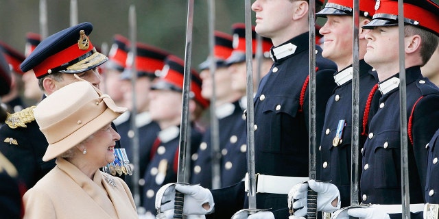 Queen Elizabeth II as a proud grandmother smiles at Prince Harry as she inspects soldiers at Sandhurst Military Academy  in Surrey, England, on April 12, 2006.