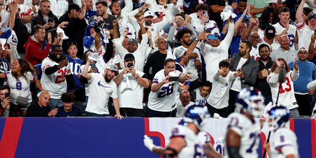 Fans celebrate after Saquon Barkley #26 of the New York Giants celebrates scored a 36 yard touchdown against the Dallas Cowboys during the third quarter in the game at MetLife Stadium on September 26, 2022 in East Rutherford, New Jersey.
