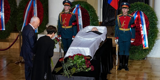 People stand by the coffin of former Soviet President Mikhail Gorbachev inside the Pillar Hall of the House of the Unions during a farewell ceremony in Moscow, Russia, Saturday, Sept. 3, 2022.