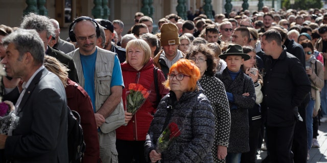 People line up to pay the last respects at the coffin of former Soviet President Mikhail Gorbachev outside the Pillar Hall of the House of the Unions during a farewell ceremony in Moscow, Russia, Saturday, Sept. 3, 2022.