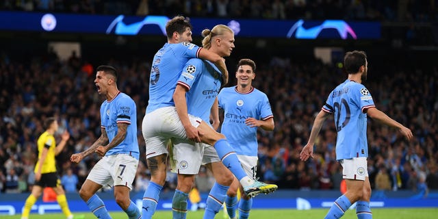 Erling Haaland of Manchester City celebrates with teammate John Stones after scoring against Dortmund at Etihad Stadium in Manchester, England, on Sept. 14, 2022.