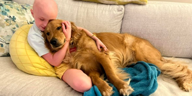 Harper Harrell hugs a dog.