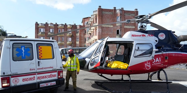 A helicopter carrying the body of famed U.S. extreme skier Hilaree Nelson lands at a hospital in Kathmandu, Nepal, on Wednesday.