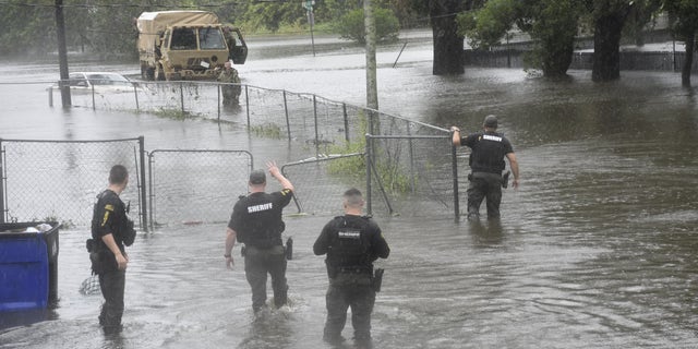 First responders from Orange County Sheriff's Office survey hurricane damage.