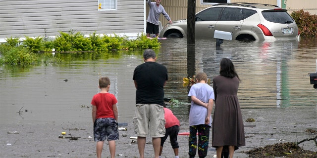Hurricane Ian: MSNBC, New York Times, and more mock DeSantis asking Biden for federal assistance 3 Residents check on one another in a flooded neighborhood in the aftermath of Hurricane Ian, Thursday, Sept. 29, 2022, in Orlando, Florida.