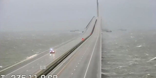 This image provided by FLDOT shows an emergency vehicle traveling on the Sunshine Skyway over Tampa Bay, Fla., on Wednesday. 