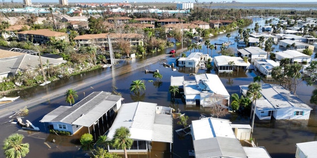 Rescue personnel search a flooded trailer park after Hurricane Ian hit the area, Sept. 29, 2022, in Fort Myers, Florida.