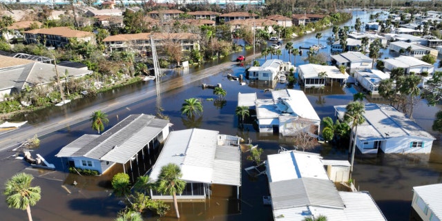 Rescue personnel search a flooded trailer park after Hurricane Ian passed by the area Thursday, Sept. 29, 2022, in Fort Myers, Florida. 