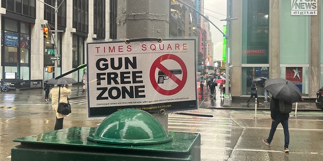 A sign zip-tied to a utility pole at the intersection of East 47th St and Avenue of The Americas declares Times Square is a gun free zone, Tuesday Sept. 6, 2022.