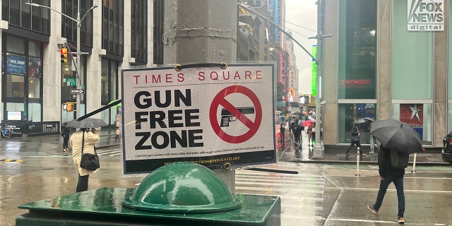 A sign zip-tied to a utility pole at the intersection of East 47th St and Avenue of The Americas declares Times Square is a gun free zone, Tuesday Sept. 6, 2022.