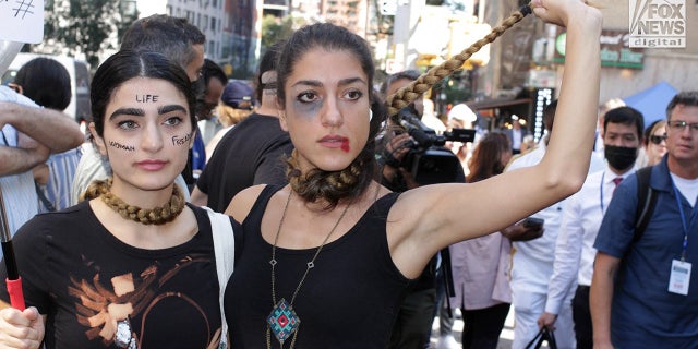 Two women vividly demonstrate their disdain for the current Iranian regime during a protest in Dag Hammerskjold Park across from the U.N. headquarters. 