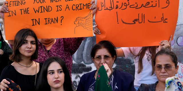 Kurdish activists hold up placards during a protest against the death of Iranian Mahsa Amini in Iran, in Martyrs' Square in central Beirut, Lebanon, on Wednesday 21 September 2022. 