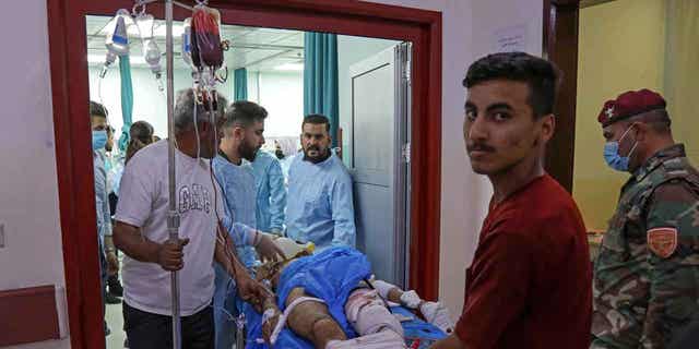 A wounded man receives treatment at a hospital following strikes by Iran in the village of Altun Kupri, in Iraq's autonomous Kurdistan region on Sept. 28, 2022. Iraq is calling on the Iranian ambassador to deliver a diplomatic complaint regarding the deadly drone bombing.