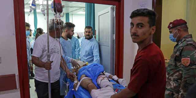 A wounded man receives treatment at a hospital following strikes by Iran in the village of Altun Kupri, in Iraq's autonomous Kurdistan region on Sept. 28, 2022. Iraq is calling on the Iranian ambassador to deliver a diplomatic complaint regarding the deadly drone bombing.