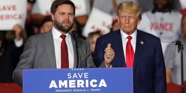 Former President Donald Trump welcomes JD Vance, Republican candidate for US Senator for Ohio, to the stage at a campaign rally in Youngstown, Ohio. Saturday, Sept. 17, 2022. (AP Photo/Tom E. Puskar)