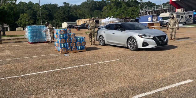 Water donation sites give residents bottled water for consumption.