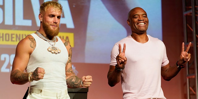 Jake Paul, left, and Anderson Silva pose for photos during a press conference on Monday, Sept. 12, 2022, in Los Angeles.  The two are scheduled to fight at a 187-pound catchweight on October 29 in Phoenix.