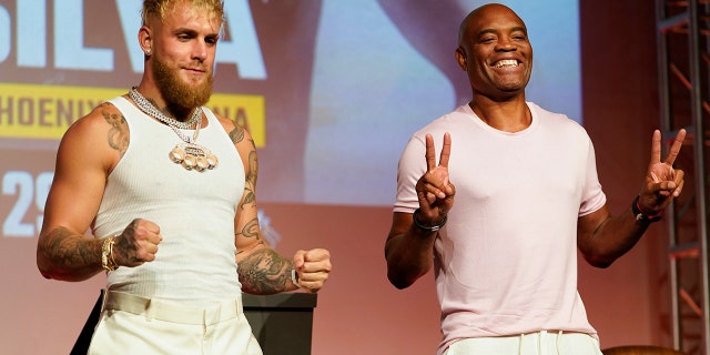 Jake Paul, left, and Anderson Silva pose for photos during a press conference on Monday, Sept. 12, 2022, in Los Angeles.  The two are scheduled to fight at a 187-pound catchweight on October 29 in Phoenix.