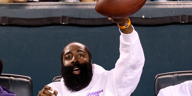 Philadelphia 76ers' James Harden reacts with a game ball during the third quarter between the Philadelphia Eagles and Minnesota Vikings at Lincoln Financial Field on September 29.  died on February 19, 2022 in Philadelphia.