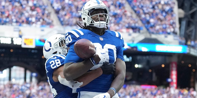 Colts' Jelani Woods celebrates after he made a touchdown reception against the Kansas City Chiefs, Sunday, Sept. 25, 2022, in Indianapolis.